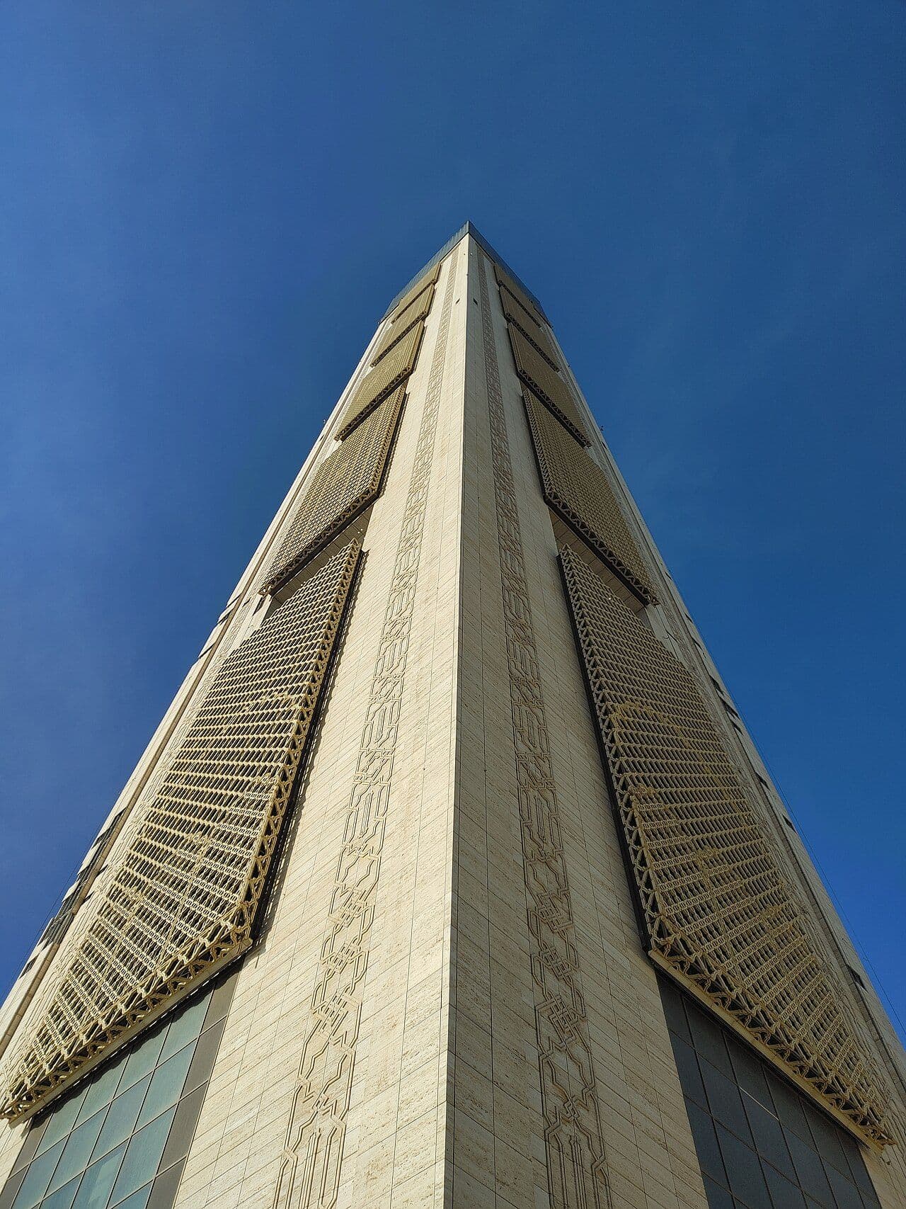The minaret of Djamaa El Djazaïr, Algiers, seen from below against a deep blue sky